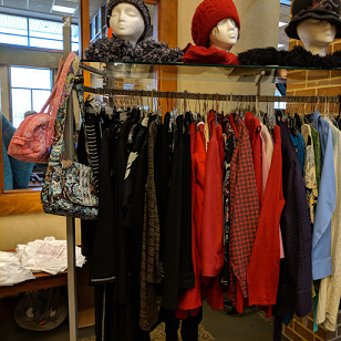 Rack of women's coats with hats and handbags