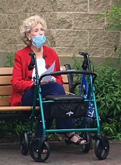 woman resident on a bench singing