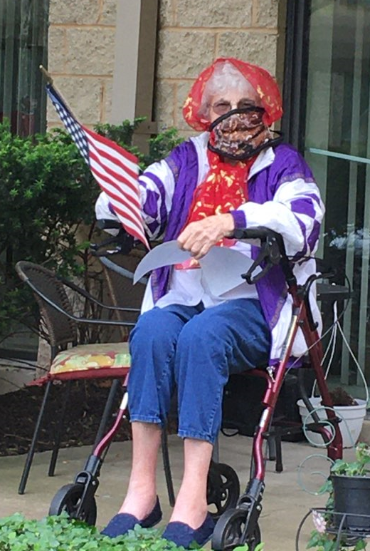 woman resident in a whair waving an American flag